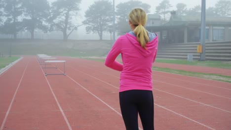 female athlete standing on a running track 4k