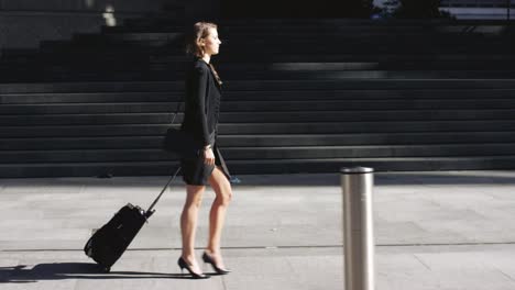 4k video footage of a businesswoman making her way to the airport with her suitcase