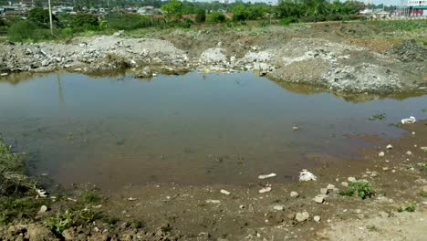 Aerial-backward-shot-of-plastic-bottles,garbage-and-waste-destroying-nature