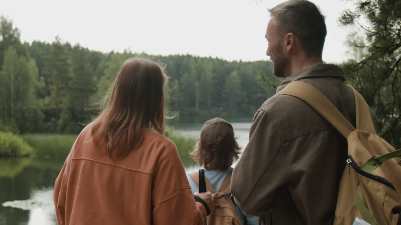 Family enjoying a scenic view of a lake in a forest