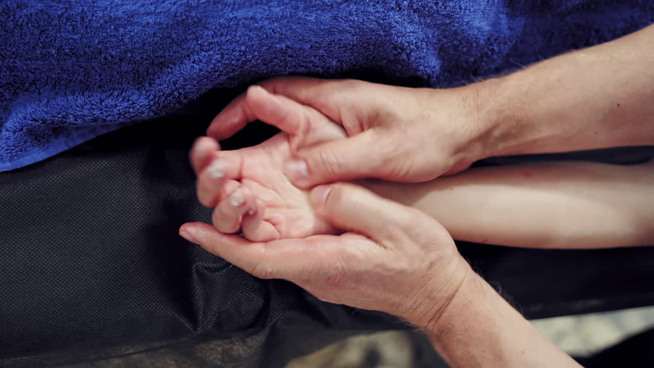 Body care at spa treatments. Woman enjoying a hand massage at the health spa