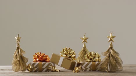 video of christmas gifts with christmas tree decoration and copy space on wooden background