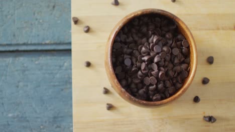 Video-of-close-up-of-bowl-with-organic-chocolate-chip-on-wooden-background