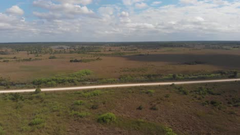 Nubes-Moviéndose-A-Través-De-Humedal-Pantano-Hierba-Horizonte-Vasto-Camino-Everglades-Florida-Drone-Aéreo