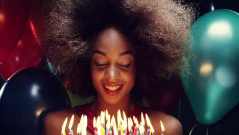 Beautiful-young-hispanic-woman-blowing-out-candles-celebrating-birthday-multicolored-balloon-background---Red-Epic-Dragon