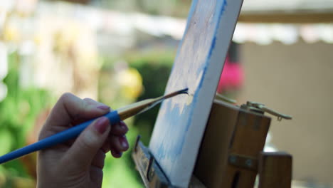 slow motion video of female artists hand applying paint to canvas