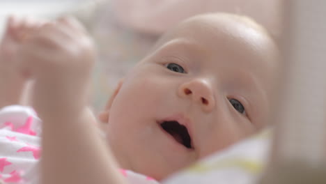 indoor portrait of lovely active two months baby girl