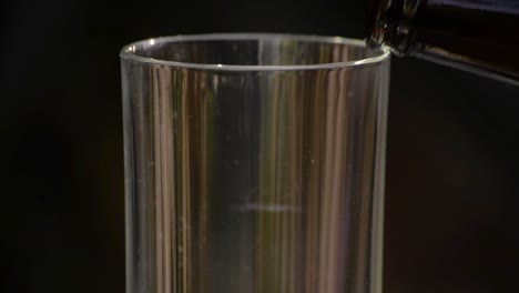 cloudy hazy pilsner ale beer being poured on a glass at sunset