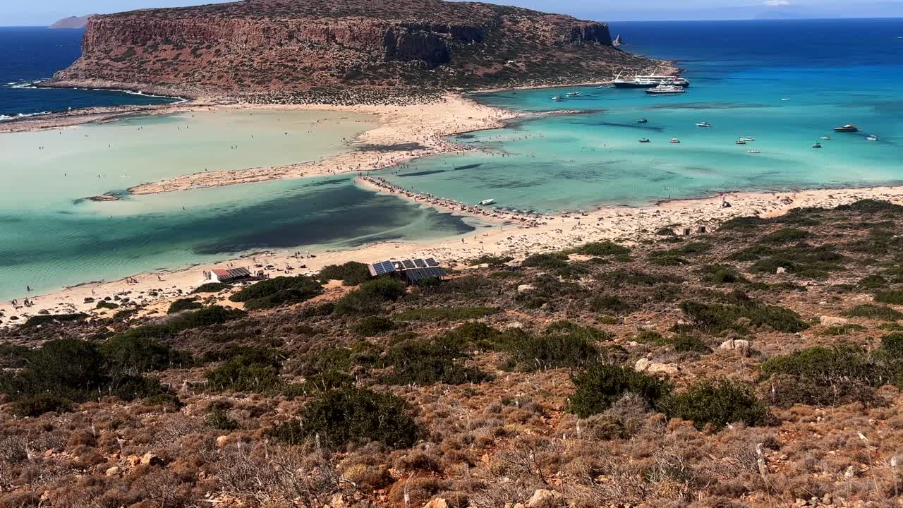 Scenic view of Balos Lagoon in Crete, Greece, with turquoise waters, sandy beach, and rugged cliffs