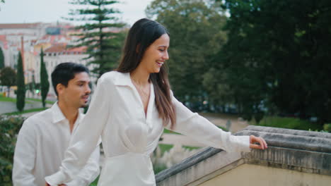 emotional newlyweds running stairs town. happy smiling couple kissing embracing