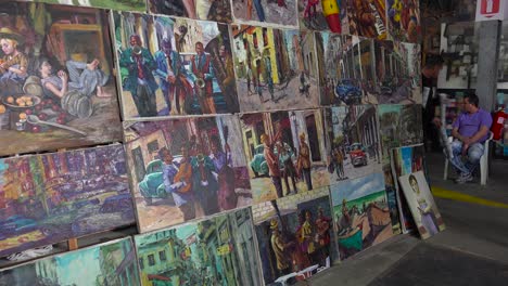 artists display their paintings in a tourist gallery in havana cuba