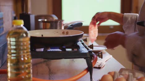 mixed race woman preparing breakfast at home