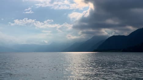 serene lake landscape with mountain range and dramatic sky