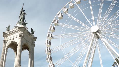 ferris wheel in the park and a statue