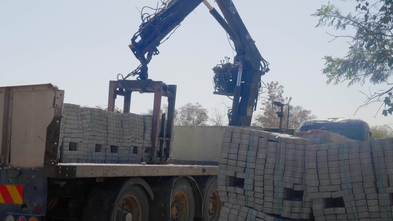 Crane truck loading or unloading paving stones