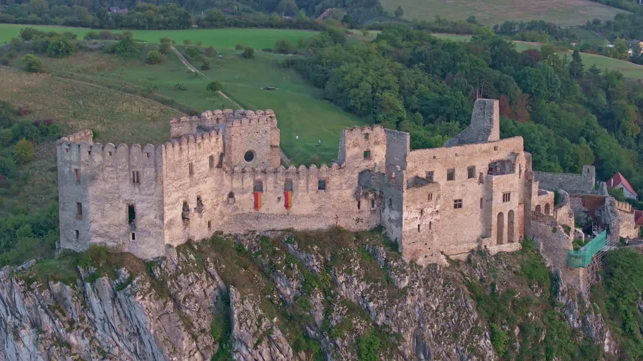 Scorcio aereo del Castello di Beckov incorniciato da colline nebbiose.