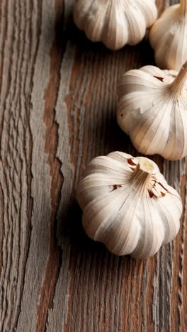 fresh garlic bulbs on wooden table