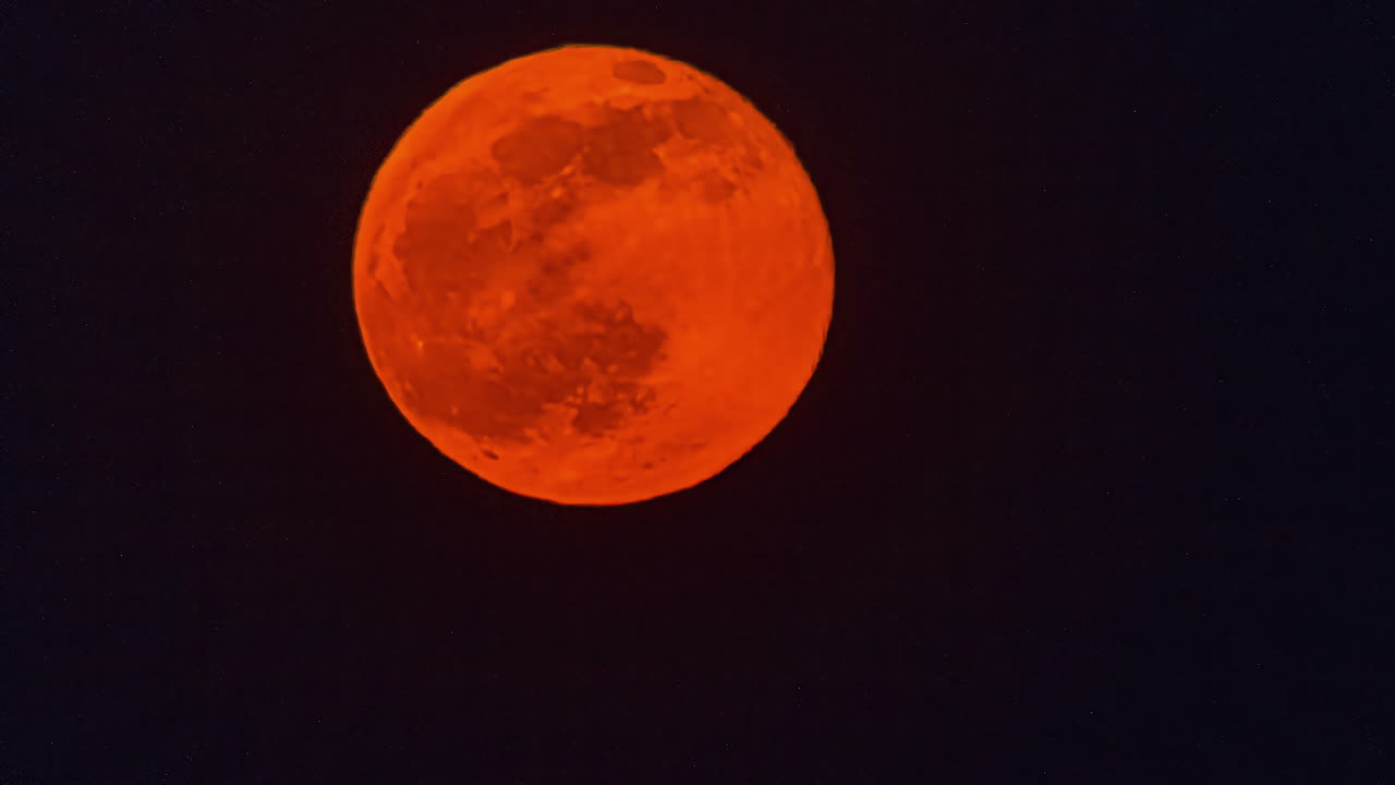 Closeup Of Red Moon Rising On The Dark Sky At Night