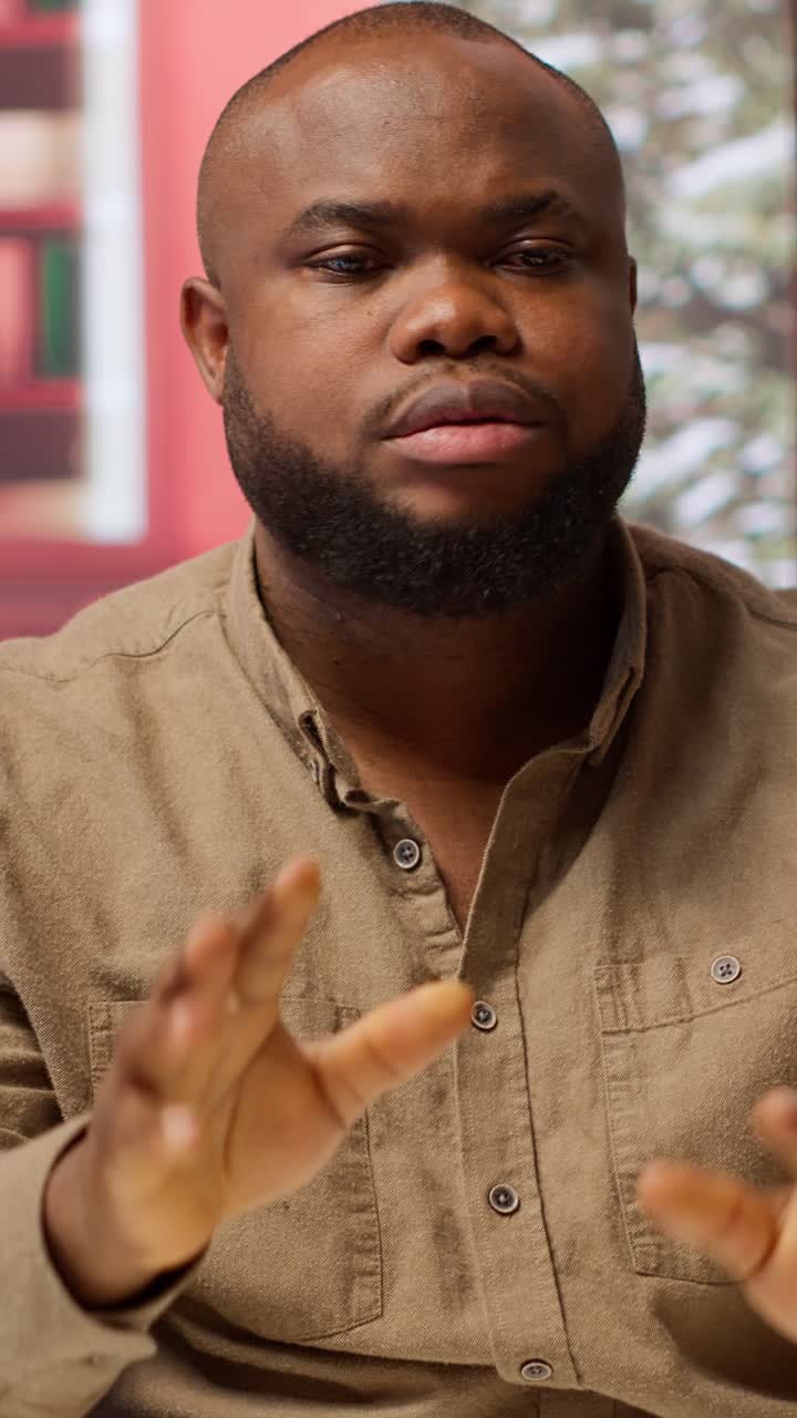 Expressive Black Man Talking and Gesturing During a Conversation