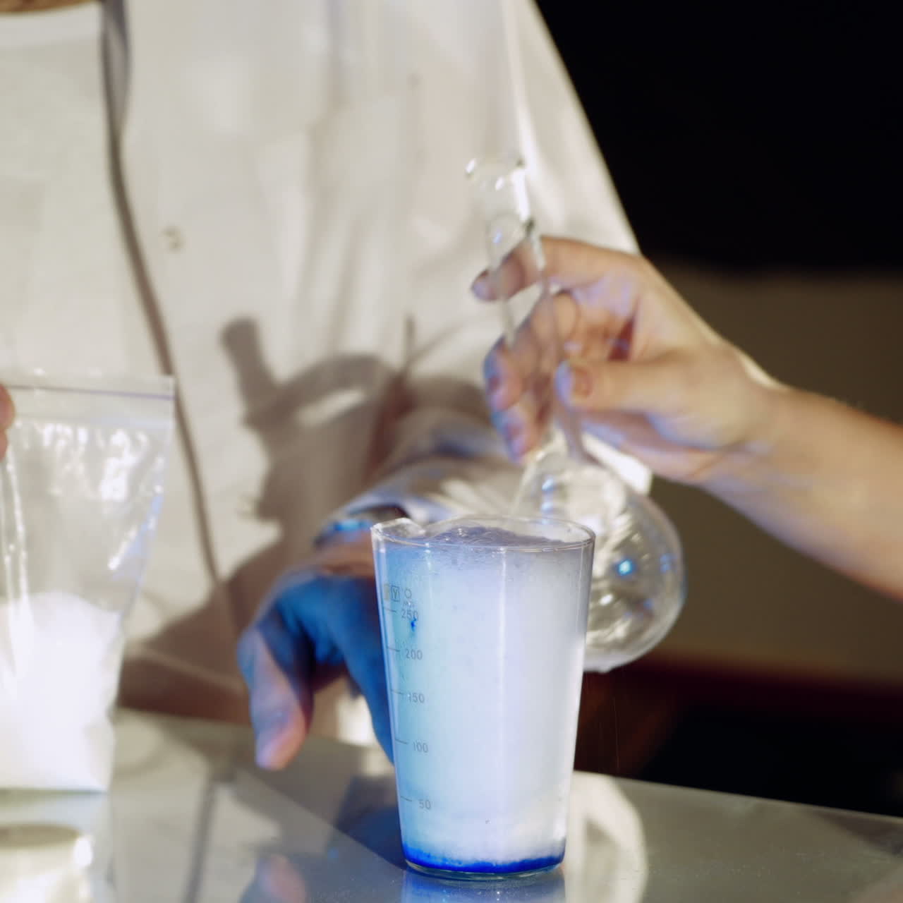 Lab worker mixes chemicals. Experiments in the laboratory. Close-up Square video