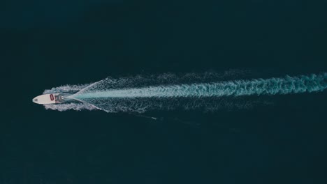 four speedboats sailing across dark