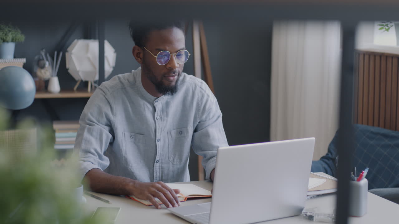 Man Working on Laptop in Home Office