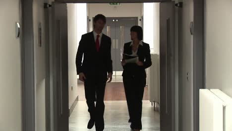 business people walking in corridor