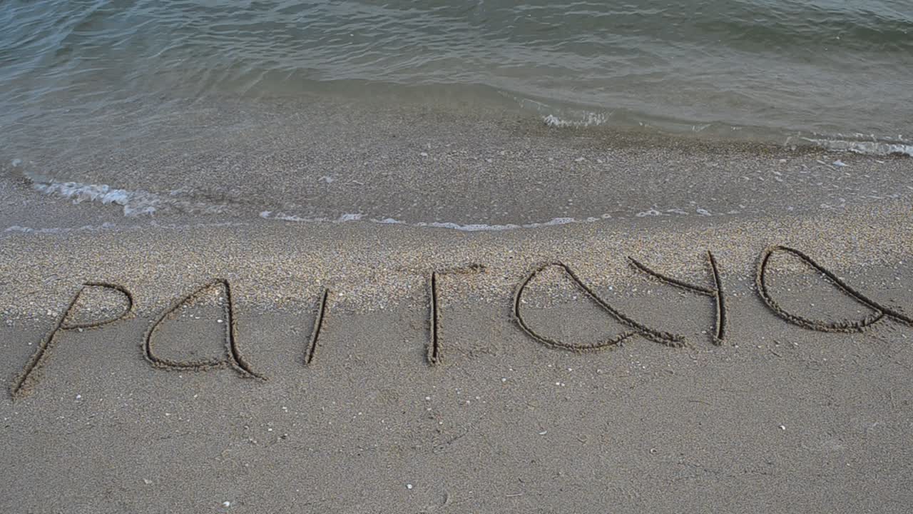 Inscription on the beach sand sign pattaya. Shooting on the beach
