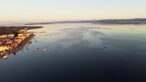 Beautiful-peaceful-coastal-town-of-Sant'Antioco,-facing-calm-lagoon-at-sunrise