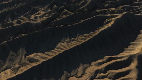 wrinkled sandstone ridges form strange landscape at factory butte, utah