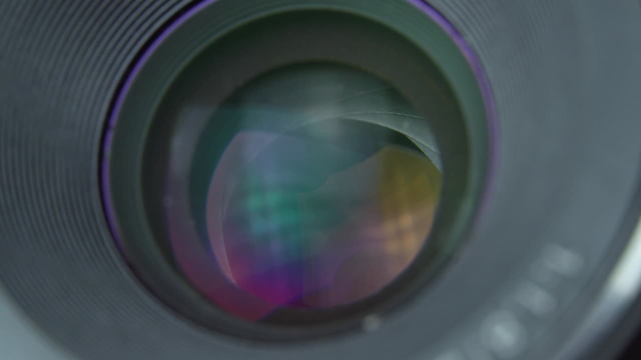 Adjusting camera lens aperture. camera aperture opens slowly and then closes.