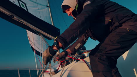 Sailing,-boat-and-man-with-rope-at-sea-for-travel