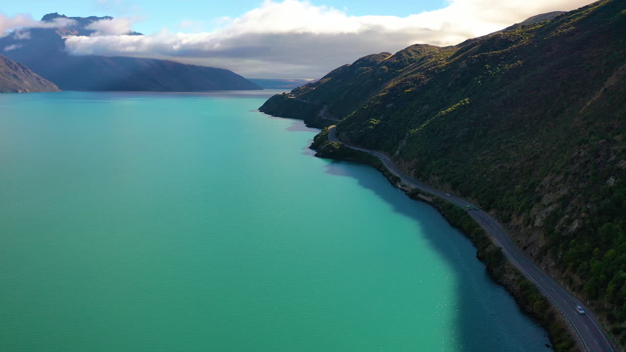 Aerial view of a picturesque highway along a stunning mountain lake in New Zealand's Southern Alps