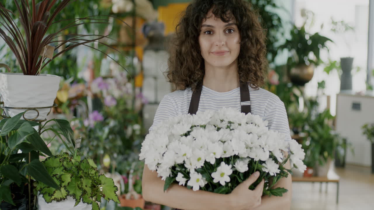 Woman Florist Holding a Bouquet of White Chrysanthemums
