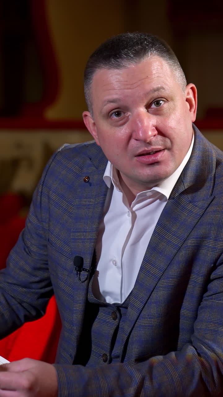 New normal in cinema theater. Portrait of man speaking on camera at theater after pandemic