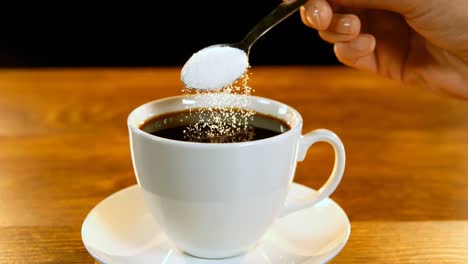 Spoon-of-sugar-poured-into-coffee-cup-4k