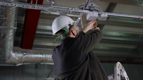 electrician working on ceiling installation