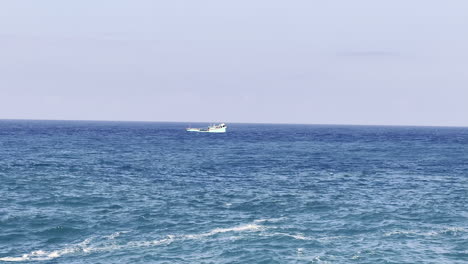 a small fishing boat on the ocean near bali, indonesia