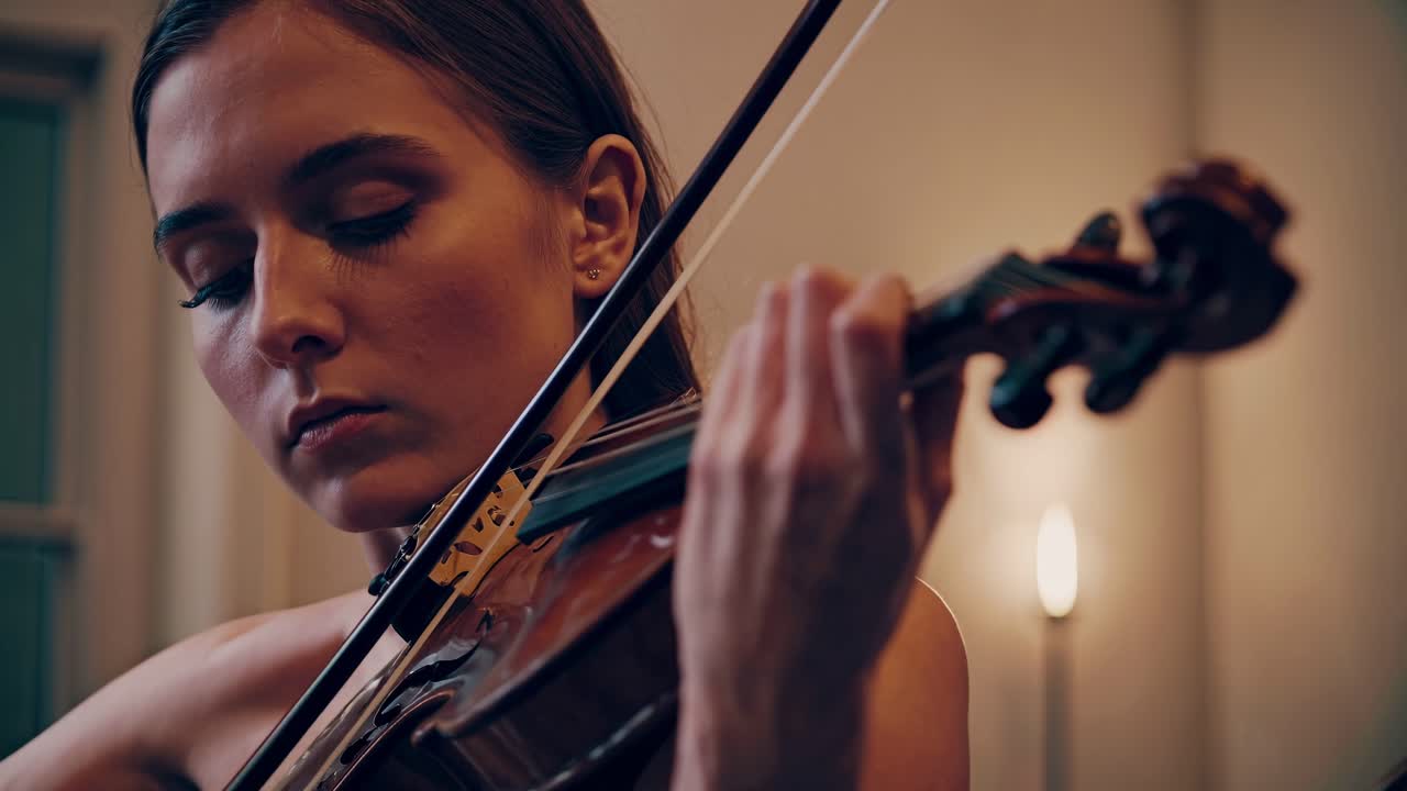Close-up video shot of a violinist playing passionately, capturing the intensity and focus