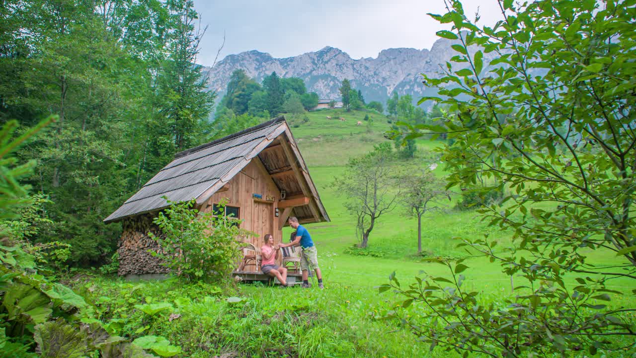 Drinking a coffee outside the mountain cabin. Beautiful nature and mountains. Topla Valley, Slovenia