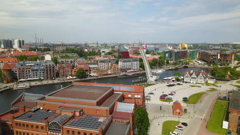 aerial view showing beautiful port and pier of gdansk with old town and historic buildings during sunny day in poland