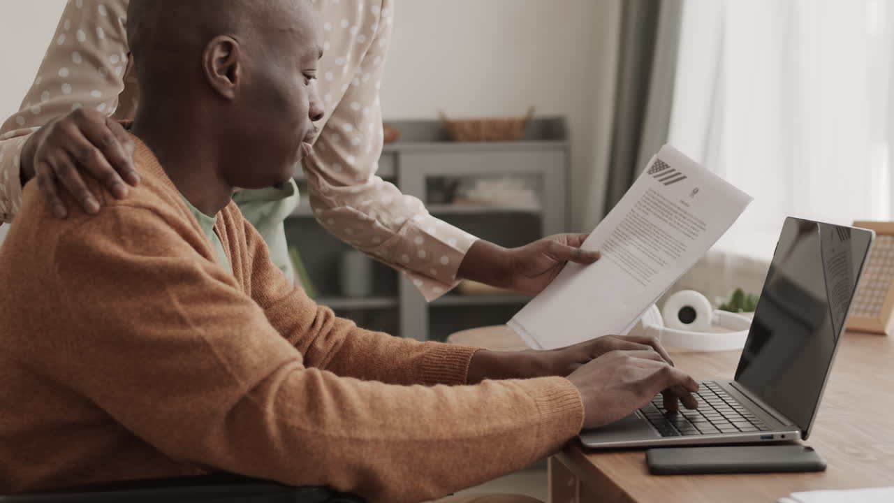 Unrecognizable Woman Helping African-American Man Doing Paperwork