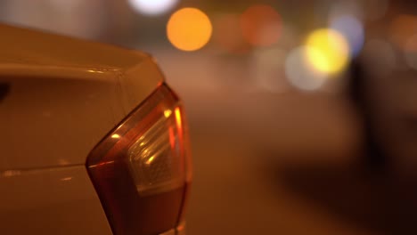 car on night city street, blurred city traffic lights.