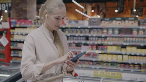 woman using mobile phone in supermarket