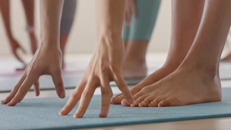 close up feet yoga class women stretching practicing half forward bend pose enjoying fitness studio training workout