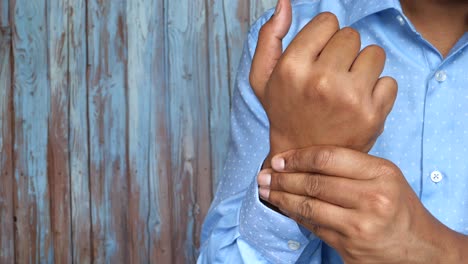 man holding his wrist in pain