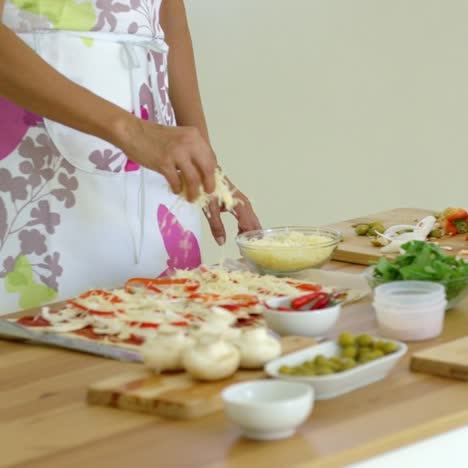 woman preparing a homemade pizza in the kitchen