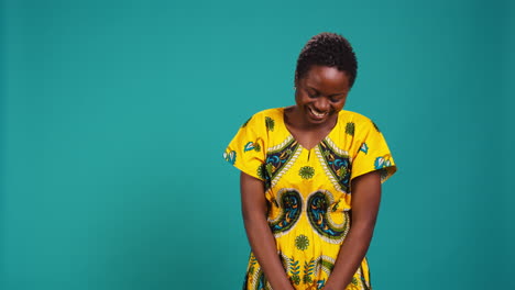 feminine natural young girl laughing at something in studio