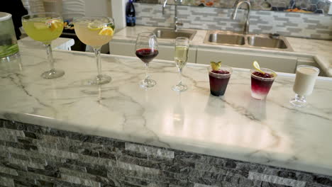 row of mixed drinks at a salon bar