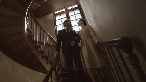 newlyweds going down the spiral staircase